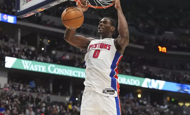 Detroit Pistons center Jalen Duren dunks the ball for a basket in the first half of an NBA basketball game against the Denver Nuggets, Saturday, Dec. 28, 2024, in Denver. (AP Photo/David Zalubowski)