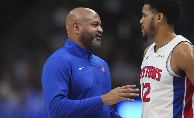 Detroit Pistons head coach J.B. Bickerstaff, left, confers with forward Tobias Harris in the first half of an NBA basketball game against the Denver Nuggets, Saturday, Dec. 28, 2024, in Denver. (AP Photo/David Zalubowski)