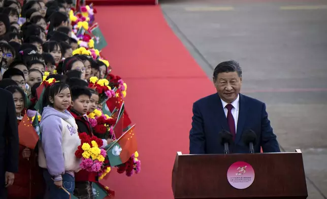 China's President Xi Jinping, right, speaks upon his arrival at the airport in Macao, China, Wednesday, Dec. 18, 2024, ahead of celebrations marking the 25th anniversary of the casino city’s return to Chinese rule. (Eduardo Leal/Pool Photo via AP)