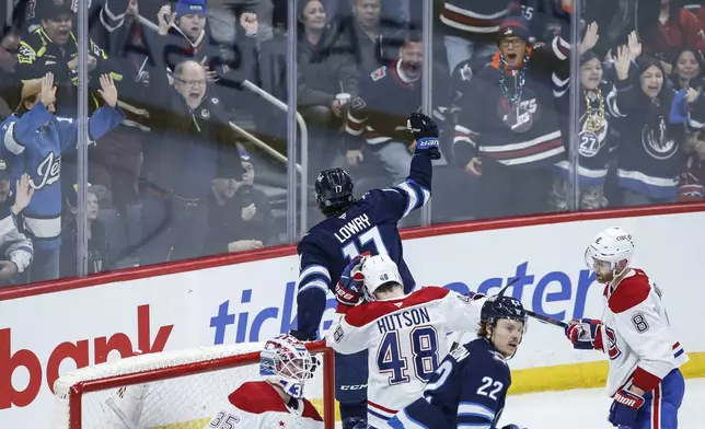 Winnipeg Jets' Adam Lowry (17) celebrates his goal against the Montreal Canadiens during the first period of an NHL hockey game, Saturday, Dec. 14, 2024 in Winnipeg, Manitoba. (John Woods/The Canadian Press via AP)