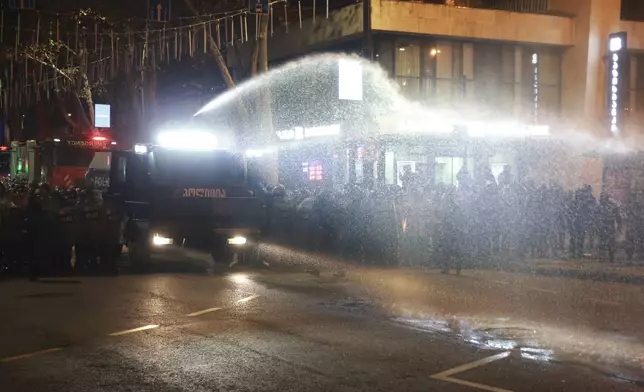 Police use a water cannon against demonstrators rallying against the government's decision to suspend negotiations on joining the European Union in Tbilisi, Georgia, early Tuesday, Dec. 3, 2024. (AP Photo/Zurab Tsertsvadze)