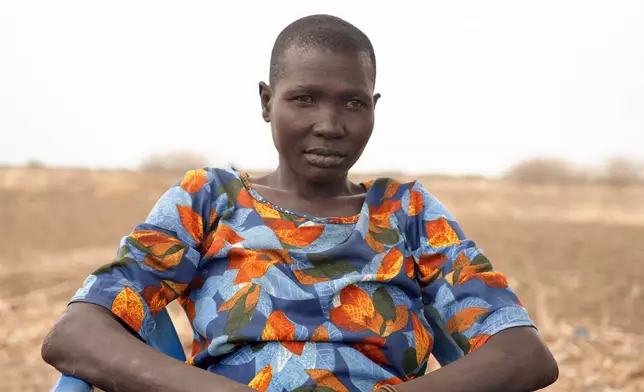 Nyingong Aguek, who contracted Guinea worm after she and her two sons drank swampy water while traveling in 2022, poses in Jarweng, South Sudan, on May 13, 2023. (AP Photo/Sam Mednick)