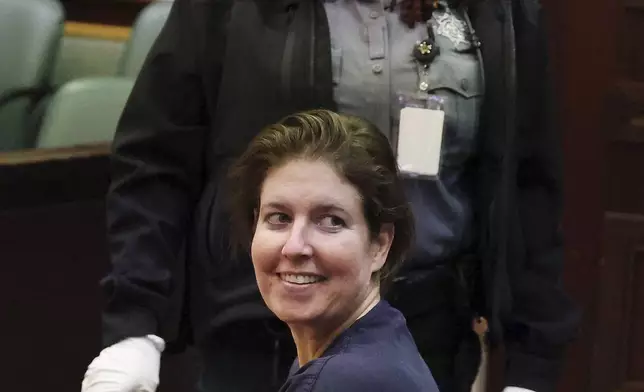 Sarah Boone smiles as she glances back at supporters in a courtroom of the Orange County Courthouse in Orlando, Florida, on Monday, Dec. 2, 2024, after she was sentenced to life in prison for murdering her boyfriend, Jorge Torres, Jr., in 2020 by suffocating him in a suitcase. (Stephen M. Dowell/Orlando Sentinel via AP)