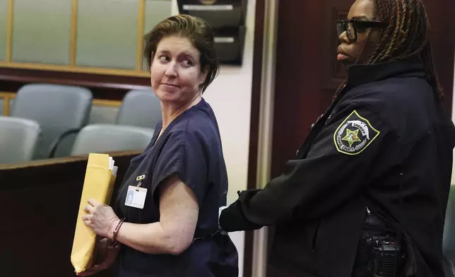 Sarah Boone is led off in handcuffs as she glances back at supporters in a courtroom of the Orange County Courthouse in Orlando, Florida, on Monday, Dec. 2, 2024. (Stephen M. Dowell/Orlando Sentinel via AP)