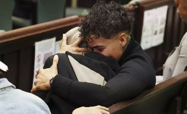 Family members of Jorge Torres, Jr. react at the sentencing of Sarah Boone in a courtroom of the Orange County Courthouse in Orlando, Florida, on Monday, Dec. 2, 2024. (Stephen M. Dowell/Orlando Sentinel via AP)