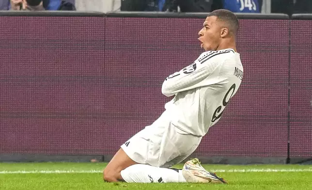 Real Madrid's Kylian Mbappe celebrates after he scored his side's first goal during the Champions League opening phase soccer match between Atalanta and Real Madrid at the Bergamo's stadium, in Bergamo, Italy, Tuesday, Dec. 10, 2024. (AP Photo/Antonio Calanni)