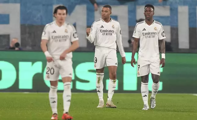 Real Madrid's Kylian Mbappe, center, celebrates with his teammates after he scored his side's first goal during the Champions League opening phase soccer match between Atalanta and Real Madrid at the Bergamo's stadium, in Bergamo, Italy, Tuesday, Dec. 10, 2024. (AP Photo/Antonio Calanni)