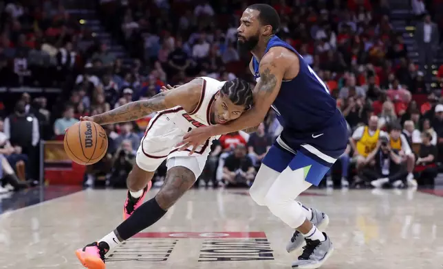 Houston Rockets guard Jalen Green, left, drives around Minnesota Timberwolves guard Mike Conley, right, during the first half of an NBA basketball game Friday, Dec. 27, 2024, in Houston. (AP Photo/Michael Wyke)