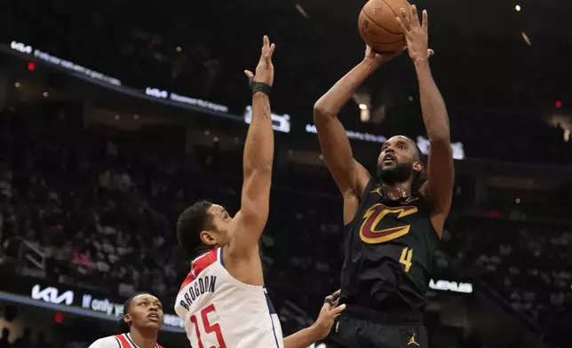 Cleveland Cavaliers forward Evan Mobley (4) shoots over Washington Wizards guard Malcolm Brogdon (15) in the first half of an NBA Cup basketball game, Tuesday, Dec. 3, 2024, in Cleveland. (AP Photo/Sue Ogrocki)