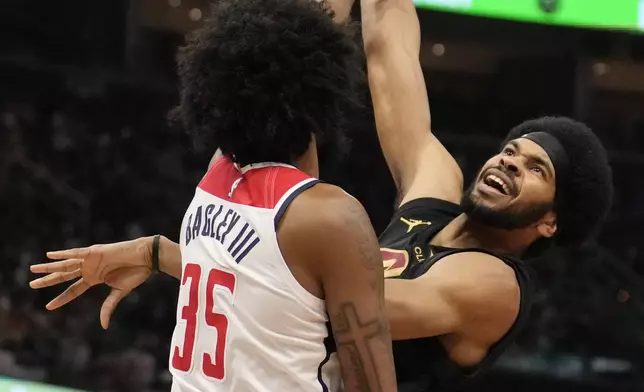 Cleveland Cavaliers center Jarrett Allen, right, shoots over Washington Wizards forward Marvin Bagley III (35) in the first half of an NBA Cup basketball game, Tuesday, Dec. 3, 2024, in Cleveland. (AP Photo/Sue Ogrocki)