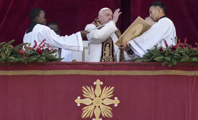 Pope Francis delivers the Urbi et Orbi (Latin for 'to the city and to the world' ) Christmas' day blessing from the main balcony of St. Peter's Basilica at the Vatican, Wednesday, Dec. 25, 2024. (AP Photo/Andrew Medichini)