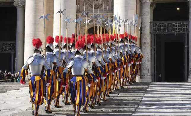 Swiss Guards march in front of St. Peter's Basilica at the Vatican, Wednesday, Dec. 25, 2024. (AP Photo/Andrew Medichini)