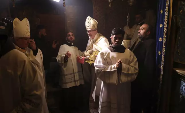 Latin Patriarch Pierbattista Pizzaballa leads the Christmas midnight Mass at the Church of the Nativity traditionally believed to be the birthplace of Jesus, in the West Bank city of Bethlehem, Wednesday Dec. 25, 2024. (Alaa Badarneh/Pool via EPA)