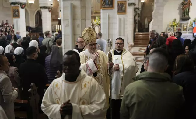 Latin Patriarch Pierbattista Pizzaballa, center, leads the Christmas morning Mass at the Chapel of Saint Catherine, traditionally believed to be the birthplace of Jesus, in the West Bank city of Bethlehem, Wednesday, Dec. 25, 2024. (AP Photo/Matias Delacroix)