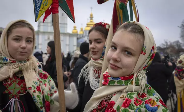 Girls in national costumes celebrate Christmas near St. Michael Monastery in a city centre in Kyiv, Ukraine, Wednesday, Dec. 25, 2024. (AP Photo/Efrem Lukatsky)