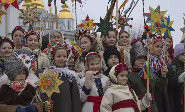 Children wearing national suits celebrate Christmas near St. Michael Monastery in a city centre in Kyiv, Ukraine, Wednesday, Dec. 25, 2024. (AP Photo/Efrem Lukatsky)