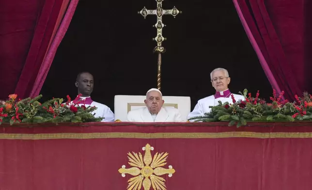 Pope Francis sits before delivering the Urbi et Orbi (Latin for 'to the city and to the world' ) Christmas' day blessing from the main balcony of St. Peter's Basilica at the Vatican, Wednesday, Dec. 25, 2024. (AP Photo/Andrew Medichini)