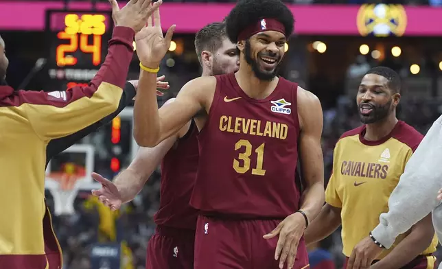 Cleveland Cavaliers center Jarrett Allen is congratulated after scoring a basket against the Denver Nuggets in the first half of an NBA basketball game Friday, Dec. 27, 2024, in Denver. (AP Photo/David Zalubowski)