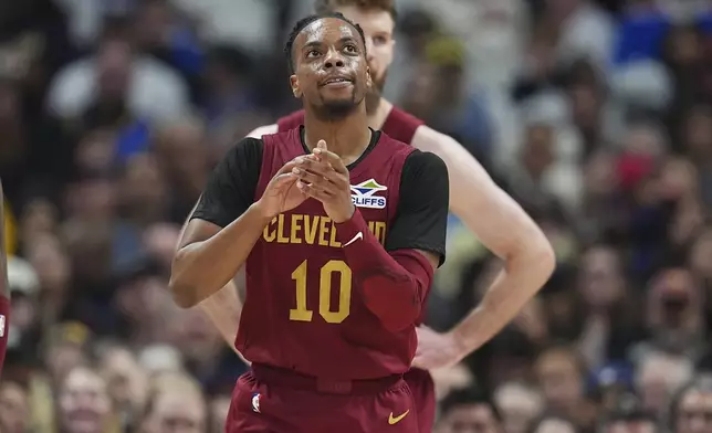 Cleveland Cavaliers guard Darius Garland reacts after scoring a basket against the Denver Nuggets in the first half of an NBA basketball game Friday, Dec. 27, 2024, in Denver. (AP Photo/David Zalubowski)