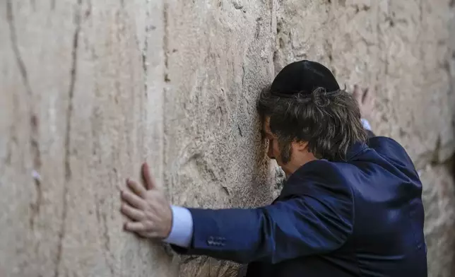 FILE- Argentine President Javier Milei prays at the Western Wall in Jerusalem's Old City, Feb. 6, 2024. Although born and raised Roman Catholic, Milei has increasingly shown public interest in Judaism and expressed intentions to convert. (AP Photo/Leo Correa, File)