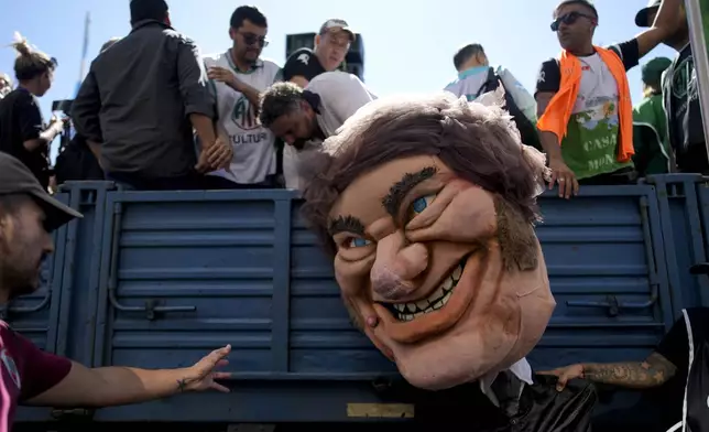 FILE - A demonstrator holds a giant doll depicting President Javier Milei during a protest demanding the reincorporation of state workers laid off as part of state economic downsizing measures in Buenos Aires, Argentina, April 5, 2024. (AP Photo/Natacha Pisarenko, File)