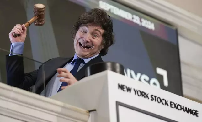 FILE - Argentina's President Javier Milei poses for pictures after ringing the opening bell at the New York Stock Exchange in New York, Sept. 23, 2024. (AP Photo/Seth Wenig, File)