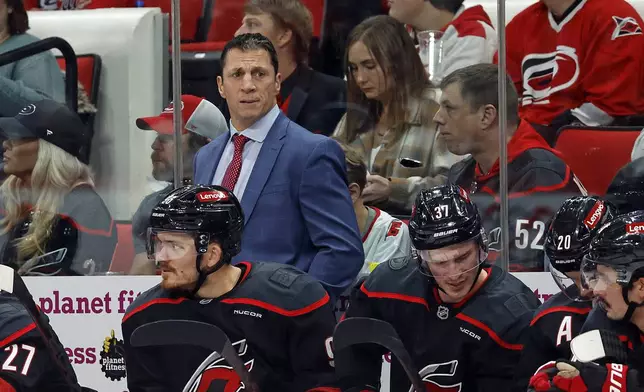 Carolina Hurricanes head coach Rod Brind'Amour watches from the sideline during the second period of an NHL hockey game against the Ottawa Senators in Raleigh, N.C., Friday, Dec. 13, 2024. (AP Photo/Karl B DeBlaker)