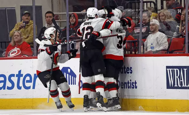 The Ottawa Senators celebrate a goal by Shane Pinto during the second period of an NHL hockey game against the Carolina Hurricanes in Raleigh, N.C., Friday, Dec. 13, 2024. (AP Photo/Karl B DeBlaker)