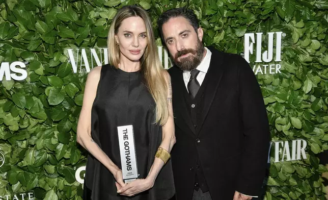 Actor Angelina Jolie, left, poses with the performer tribute award for her role in "Maria" with filmmaker Pablo Larrain during The Gothams Film Awards at Cipriani Wall Street on Monday, Dec. 2, 2024, in New York. (Photo by Evan Agostini/Invision/AP)