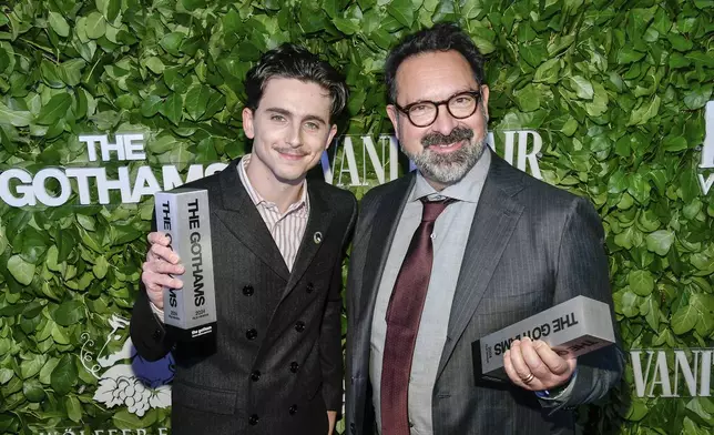 Timothee Chalamet, left, and James Mangold pose with the visionary tribute award for "A Complete Unknown" during The Gothams Film Awards at Cipriani Wall Street on Monday, Dec. 2, 2024, in New York. (Photo by Evan Agostini/Invision/AP)