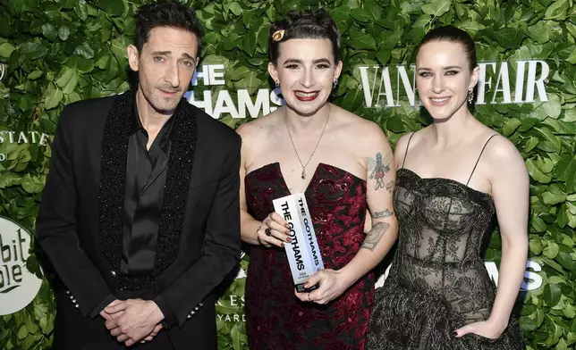 Director Vera Drew, center, poses with the breakthrough director award for "The People's Joker" with actors Adrien Brody, left, and Rachel Brosnahan during The Gothams Film Awards at Cipriani Wall Street on Monday, Dec. 2, 2024, in New York. (Photo by Evan Agostini/Invision/AP)