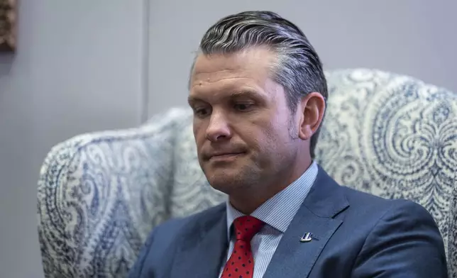 Pete Hegseth, President-elect Donald Trump's nominee to be defense secretary, listens to reporters during a meeting with Sen. Mike Rounds, R-S.D., a member of the Senate Armed Services Committee, at the Capitol in Washington, Thursday, Dec. 5, 2024. (AP Photo/J. Scott Applewhite)