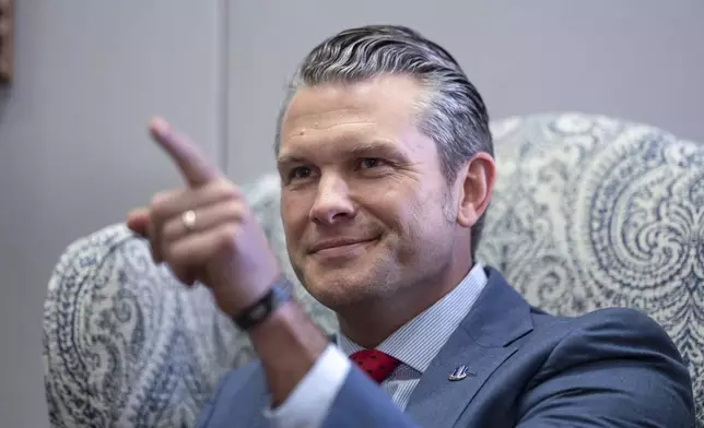 Pete Hegseth, President-elect Donald Trump's nominee to be defense secretary, responds to reporters during a meeting with Sen. Mike Rounds, R-S.D., a member of the Senate Armed Services Committee, at the Capitol in Washington, Thursday, Dec. 5, 2024. (AP Photo/J. Scott Applewhite)