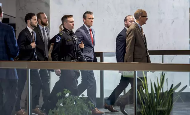 Pete Hegseth, center, President-elect Donald Trump's nominee to be defense secretary, is escorted to meet with Sen. Mike Rounds, R-S.D., a member of the Senate Armed Services Committee, at the Capitol in Washington, Thursday, Dec. 5, 2024. (AP Photo/J. Scott Applewhite)