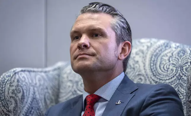 Pete Hegseth, President-elect Donald Trump's nominee to be defense secretary, responds to reporters during a meeting with Sen. Mike Rounds, R-S.D., a member of the Senate Armed Services Committee, at the Capitol in Washington, Thursday, Dec. 5, 2024. (AP Photo/J. Scott Applewhite)