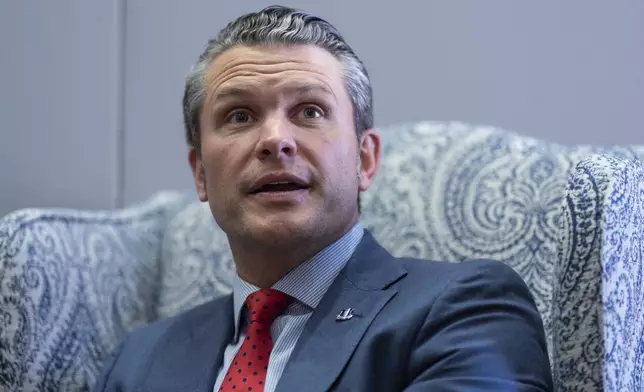 Pete Hegseth, President-elect Donald Trump's nominee to be defense secretary, responds to reporters during a meeting with Sen. Mike Rounds, R-S.D., a member of the Senate Armed Services Committee, at the Capitol in Washington, Thursday, Dec. 5, 2024. (AP Photo/J. Scott Applewhite)