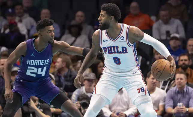 Philadelphia 76ers forward Paul George (8) looks to drive against Charlotte Hornets forward Brandon Miller during the first half of an NBA Cup basketball game in Charlotte, N.C., Tuesday, Dec. 3, 2024. (AP Photo/Nell Redmond)