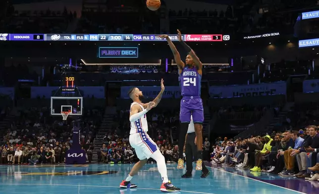 Charlotte Hornets forward Brandon Miller (24) shoots over Philadelphia 76ers forward Caleb Martin during the first half of an NBA Cup basketball game in Charlotte, N.C., Tuesday, Dec. 3, 2024. (AP Photo/Nell Redmond)