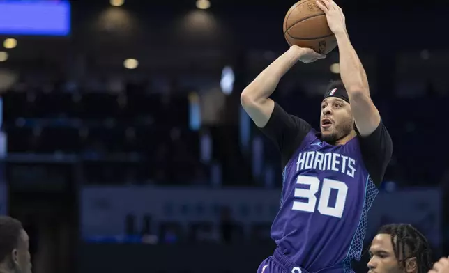 Charlotte Hornets guard Seth Curry shoots against the Philadelphia 76ers during the first half of an NBA Cup basketball game in Charlotte, N.C., Tuesday, Dec. 3, 2024. (AP Photo/Nell Redmond)