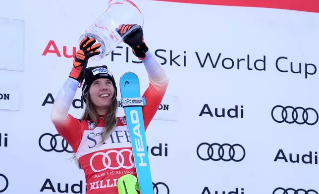 Camille Rast, of Switzerland, celebrates after her victory in a women's World Cup slalom skiing race, Sunday, Dec. 1, 2024, in Killington, Vt. (AP Photo/Robert F. Bukaty)