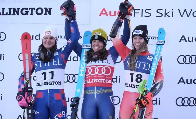 Sara Hector, of Sweden, center, celebrates her victory in a women's World Cup slalom skiing race with second place finisher Zrinka Ljutic, of Croatia, left, and third place Camille Rast, of Switzerland, Saturday, Nov. 30, 2024, in Killington, Vt. (AP Photo/Robert F. Bukaty)