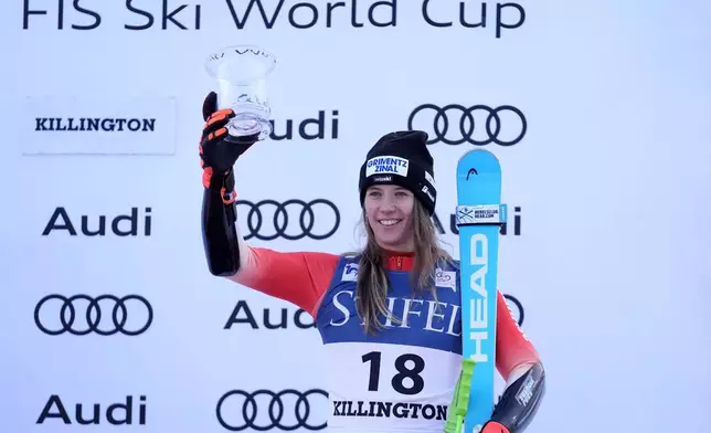 Camille Rast, of Switzerland, celebrates her third place finish in a women's World Cup giant slalom skiing race, Saturday, Nov. 30, 2024, in Killington, Vt. (AP Photo/Robert F. Bukaty)