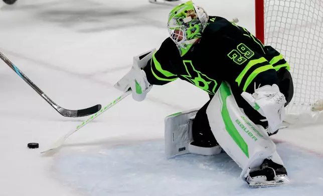 Dallas Stars goaltender Jake Oettinger makes a save during the third period of an NHL hockey game against the Washington Capitals in Dallas, Monday, Dec. 16, 2024. (AP Photo/Gareth Patterson)