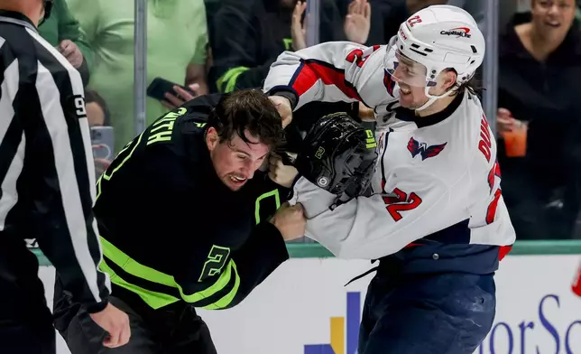 Washington Capitals right wing Brandon Duhaime (22) punches Dallas Stars defenseman Brendan Smith (2) during the second period of an NHL hockey game in Dallas, Monday, Dec. 16, 2024. (AP Photo/Gareth Patterson)