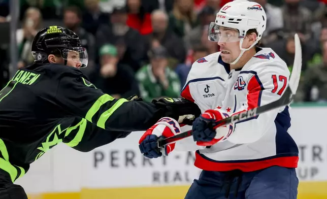 Washington Capitals center Dylan Strome (17) is defended by Dallas Stars center Logan Stankoven, left, during the second period of an NHL hockey game in Dallas, Monday, Dec. 16, 2024. (AP Photo/Gareth Patterson)