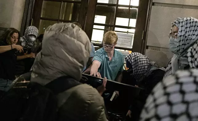 Students try to prevent the Gaza Solidarity Encampment from taking over Hamilton Hall at Columbia University on Tuesday, April 30, in New York. (Marco Postigo Storel via AP)