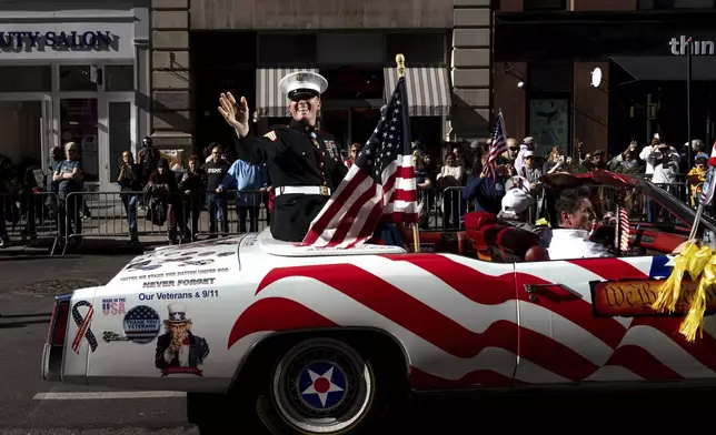 Grand Marshal Dakota Meyer, U.S. Marine Corps, a Medal of Honor recipient, waves from a car during the annual Veterans Day Parade, Monday, Nov. 11, 2024, in New York. (AP Photo/Adam Gray)