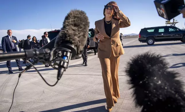 Democratic presidential nominee Vice President Kamala Harris walks toward reporters to speak before boarding Air Force Two, as she departs Las Vegas from Harry Reid International Airport, Thursday, Oct. 10, 2024, en route to Arizona. (AP Photo/Jacquelyn Martin)