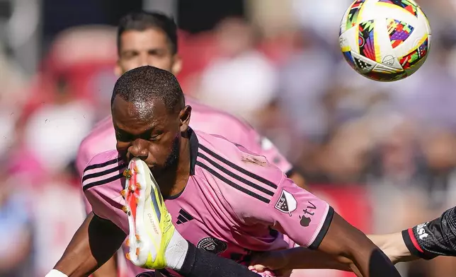 Inter Miami striker Shanyder Borgelin competes for the ball against DC United left wing back Pedro Santos during the second half of an MLS soccer match at Audi Field, Saturday, March 16, 2024, in Washington. (AP Photo/Nathan Howard)