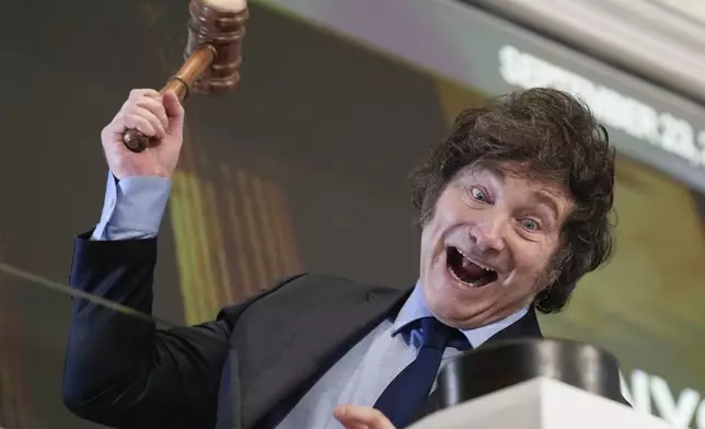 Argentina's President Javier Milei poses for pictures after ringing the opening bell at the New York Stock Exchange in New York, Monday, Sept. 23, 2024. (AP Photo/Seth Wenig)